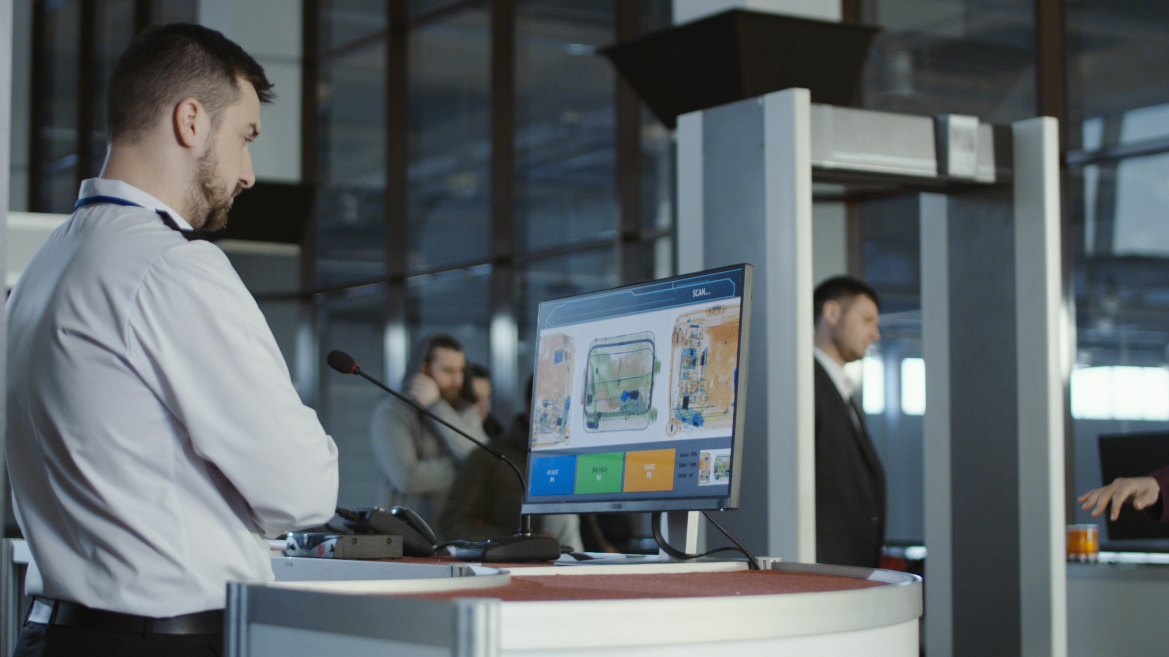 Man in uniform standing at counter at luggage checking point