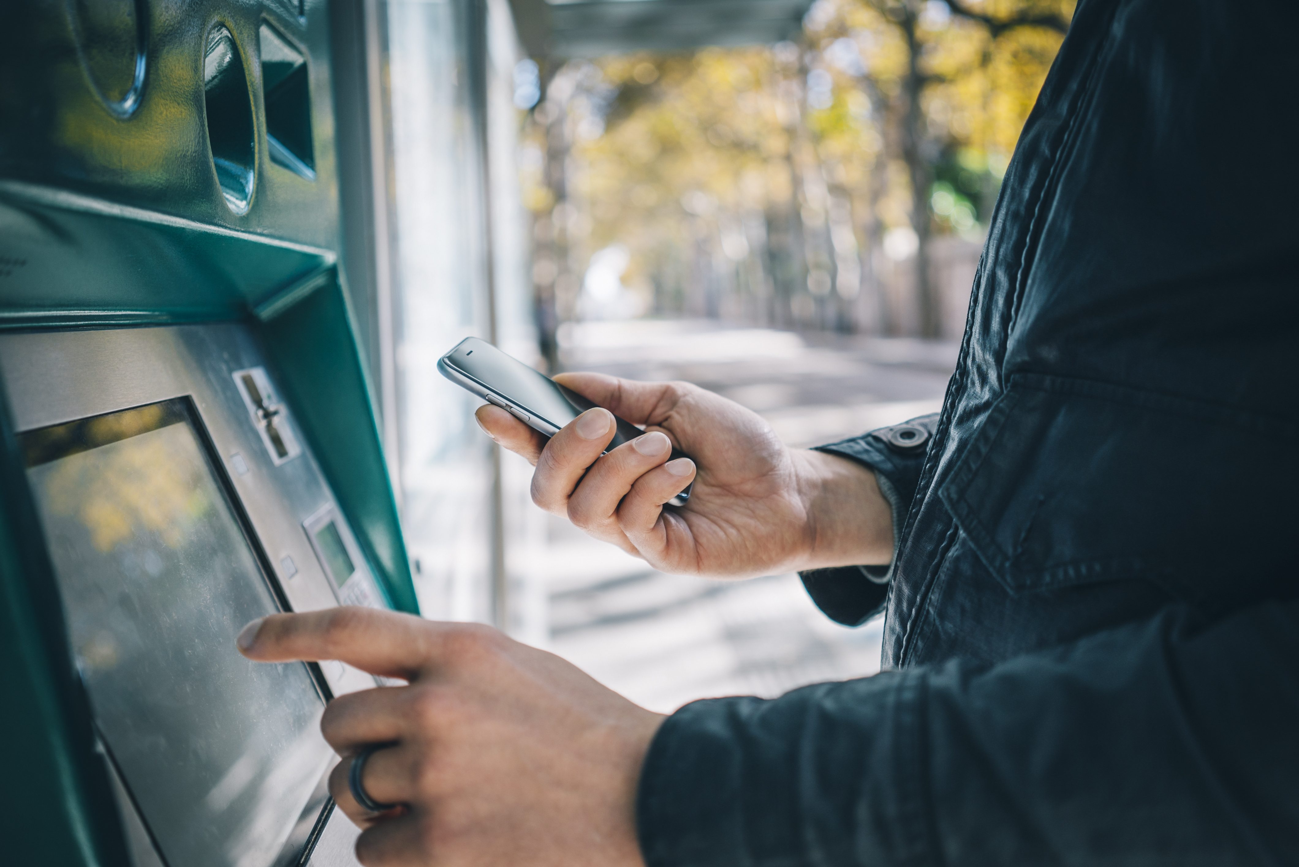 Close-up of someone using an ATM machine