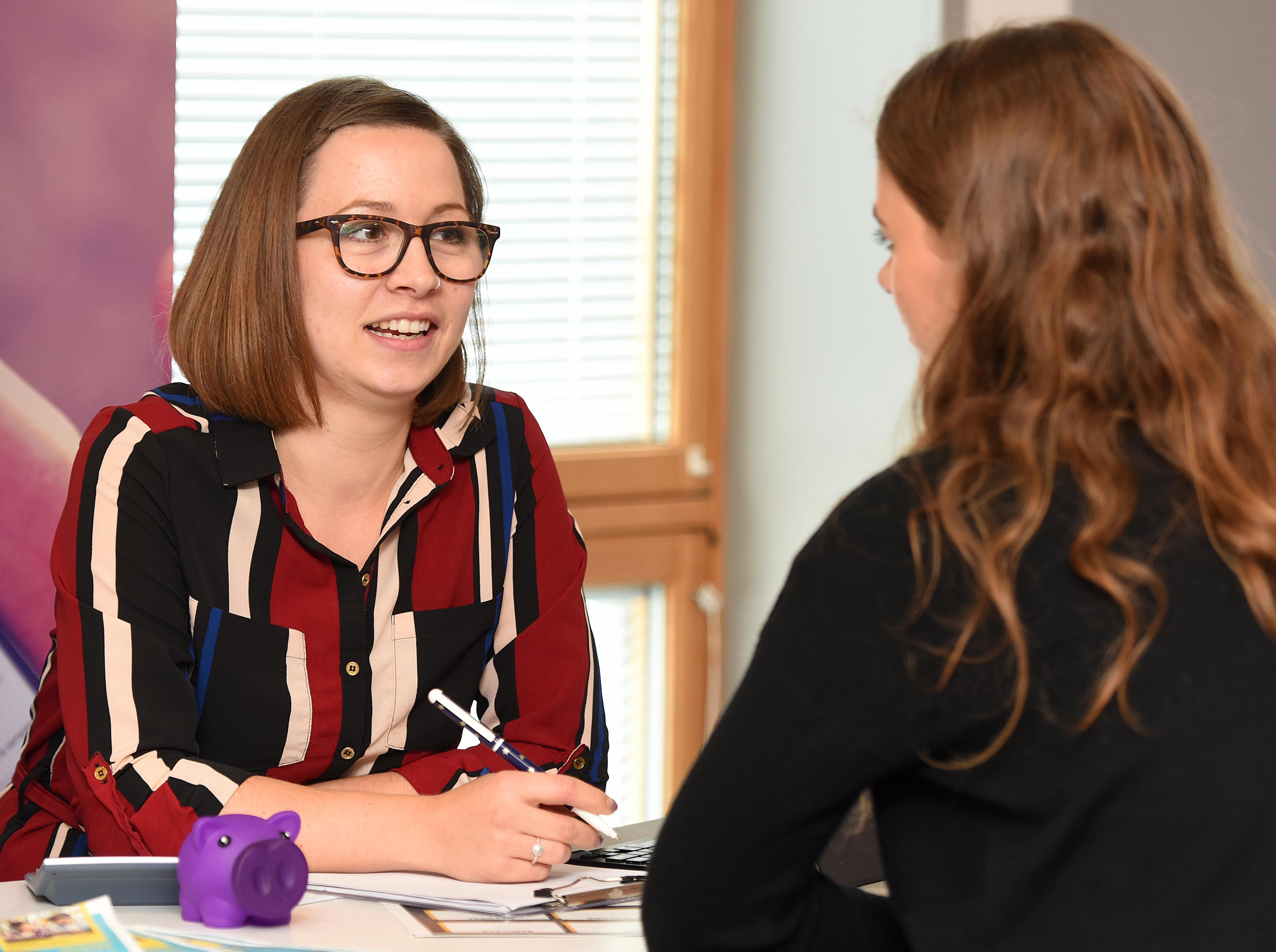 Student talking about finance with a member of staff